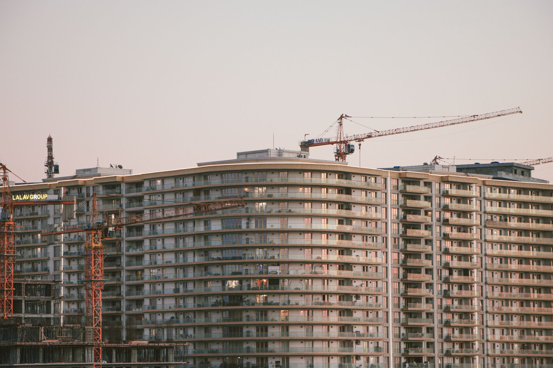 Tower cranes over high rise buildings under construction on a clear day