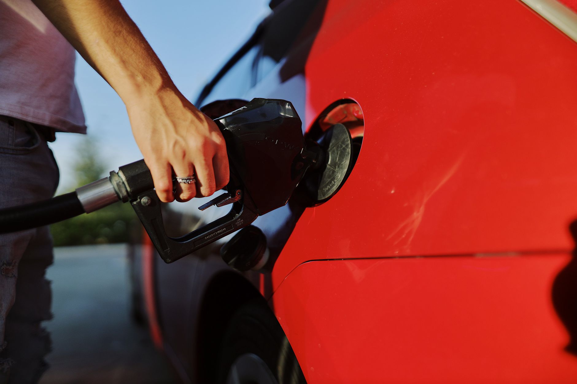 Close up of a person refuelling a car at a gas station